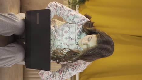 Vertical-video-of-Young-woman-focusing-on-computer-has-serious-expression.